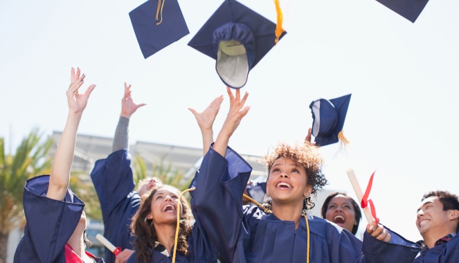 graduates tossing their hats