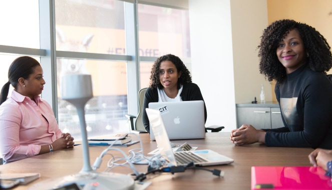 women around table working and smiling