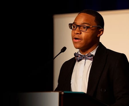 Marquis speaking at podium