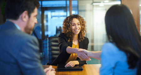 Job seeker shakes hands with employer