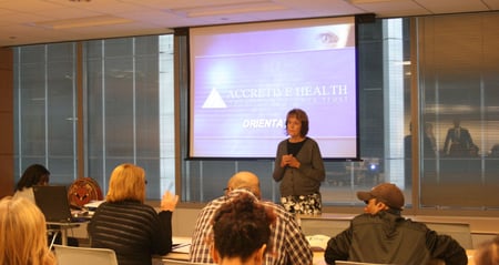 woman speaking in front of project screen