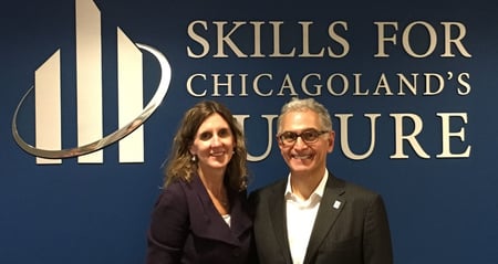 Marie and Greg in front of Skills logo