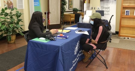 job seeker at Chicago Public Schools booth during hiring fair