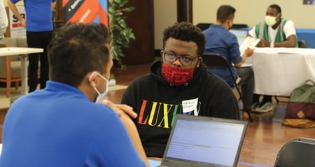 Skills for Chicagoland's Future talent acquisition staff member interviews job seeker at hiring event.