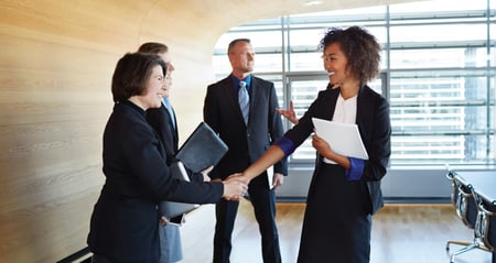 co-workers shaking hands in the office